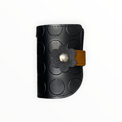 Mini pochette portachiavi TOOitaly nera con motivo circolare e dettaglio floreale nero e ocra