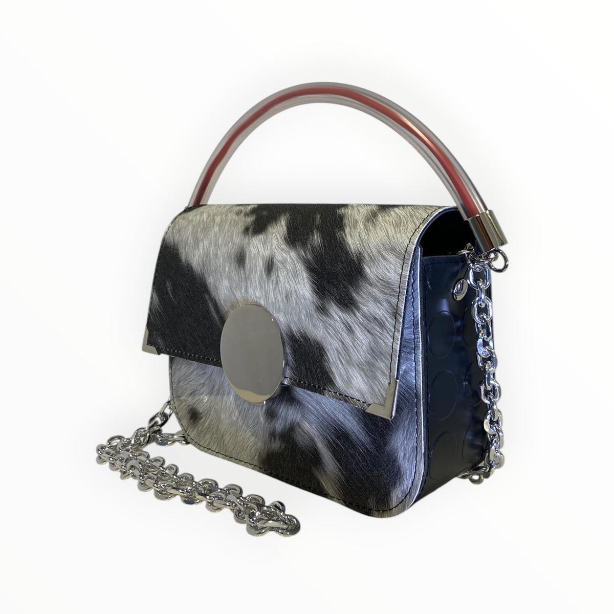 Borsa a mano Chicca XL TOOitaly effetto muccato realistico in tessuto impermeabile con chiusura circolare a specchio, manico trasparente e catena.