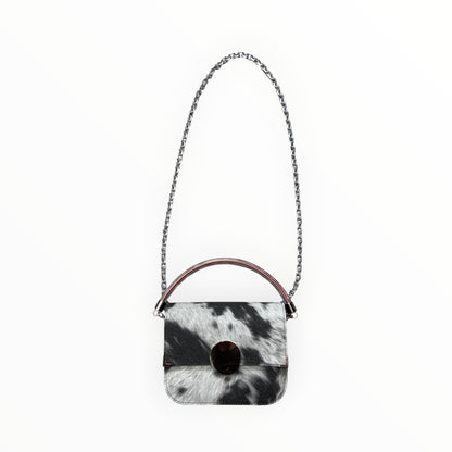 Borsa a tracolla Chicca XL TOOitaly effetto muccato in tessuto impermeabile serigrafato con catena in metallo e manico trasparente.